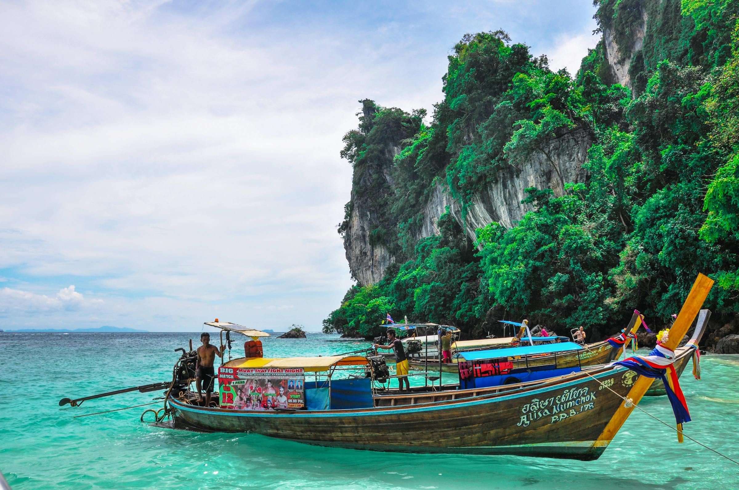Phuket — a colourful longtail boat on crystal Andaman water
